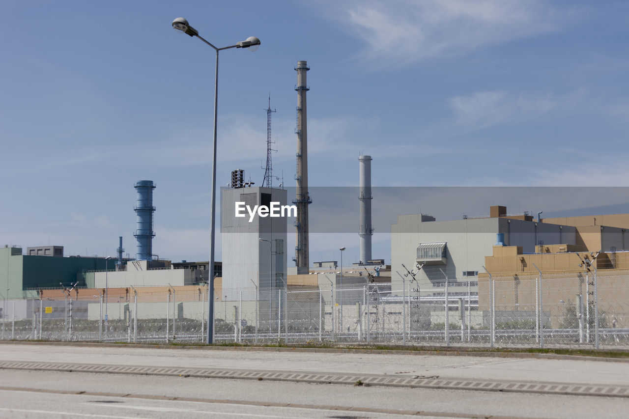 Low angle view of smoke stack against sky