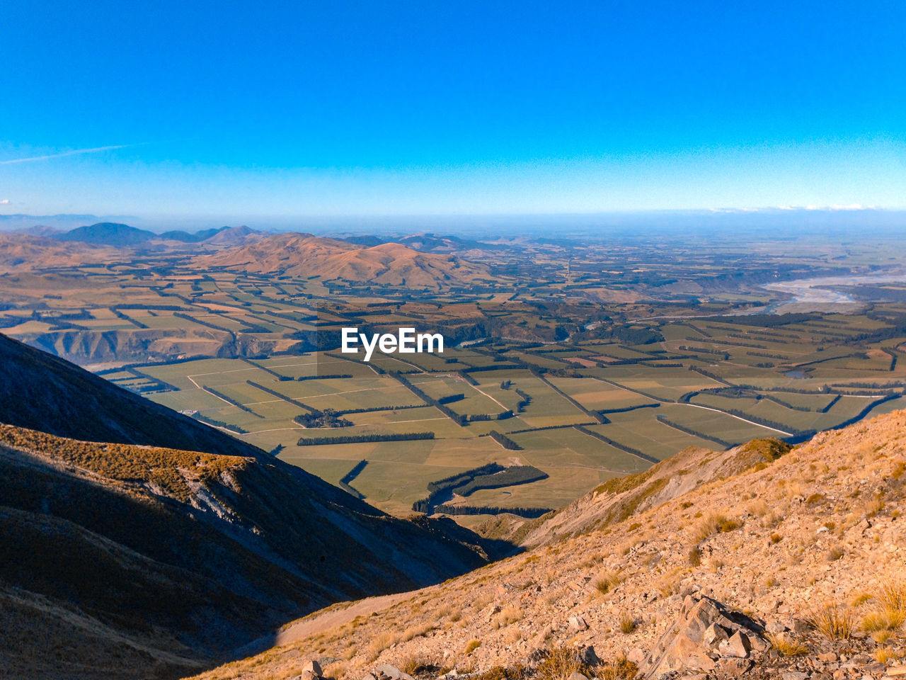 High angle view of landscape against blue sky