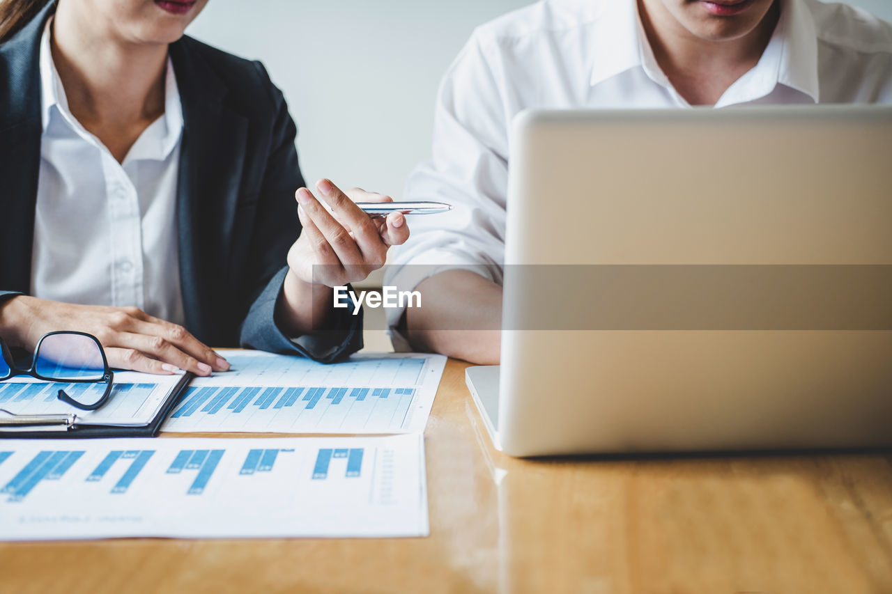 Midsection of business colleagues working in office