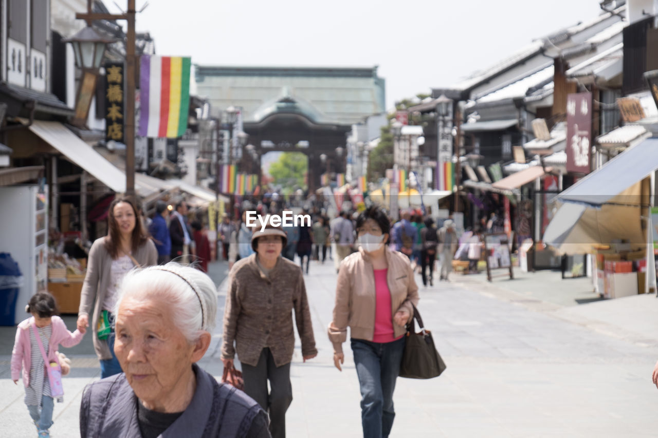 PEOPLE WALKING IN CITY