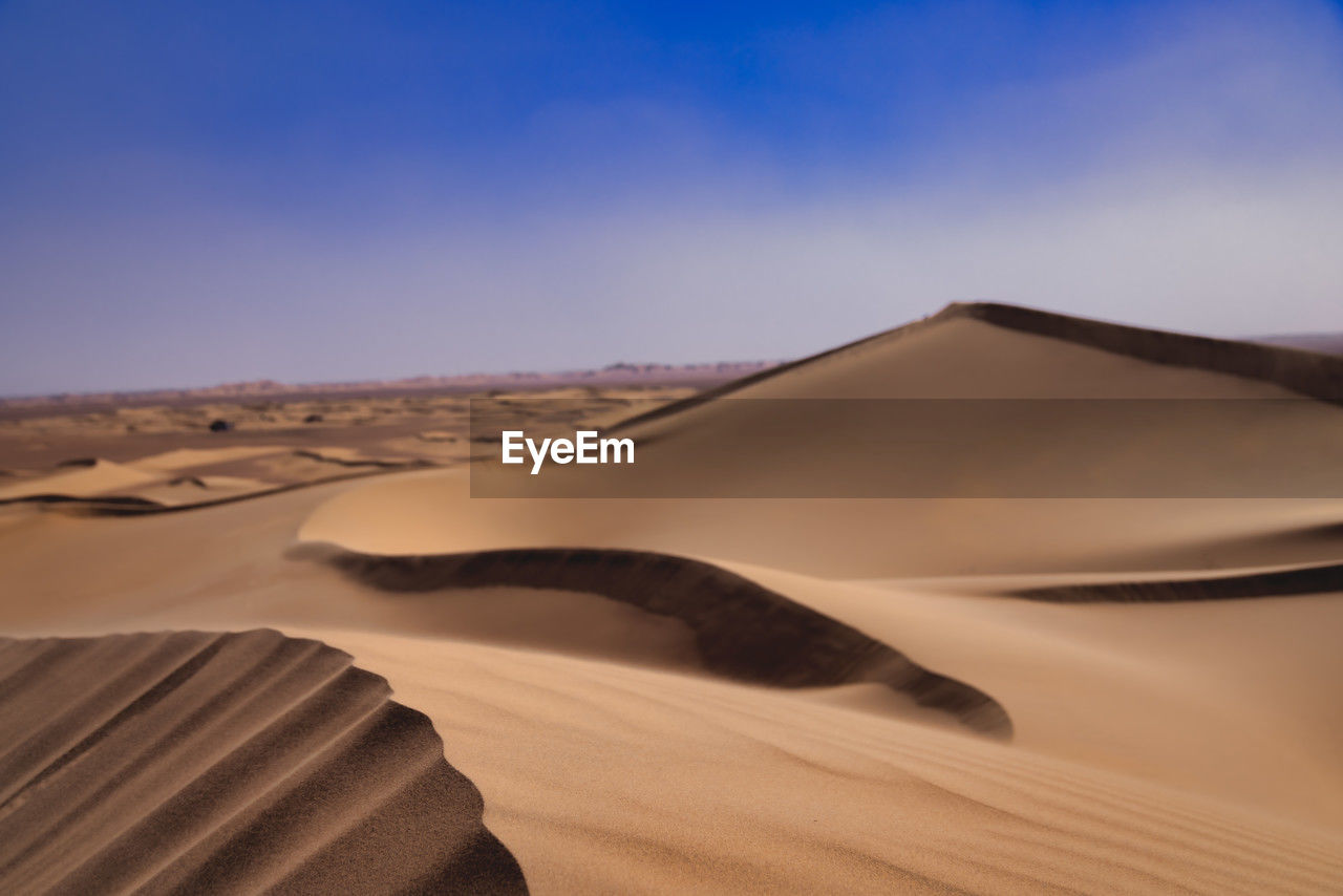 sand dunes in desert against clear sky