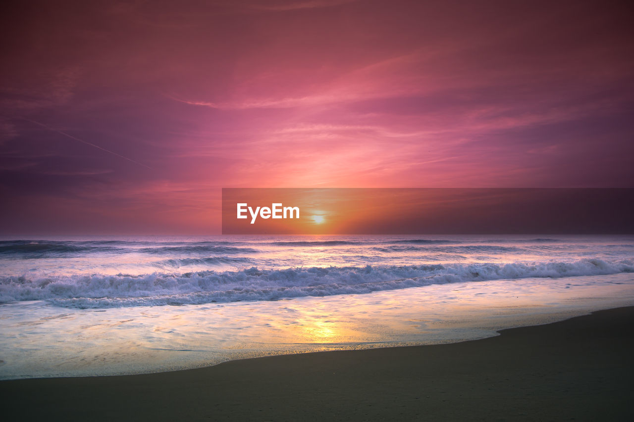 SCENIC VIEW OF BEACH DURING SUNSET