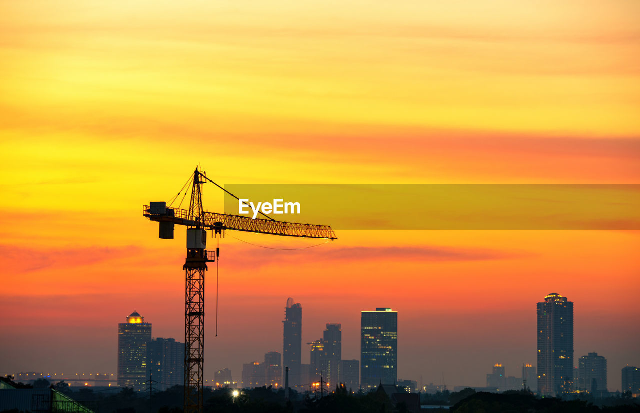 CRANES AT CONSTRUCTION SITE