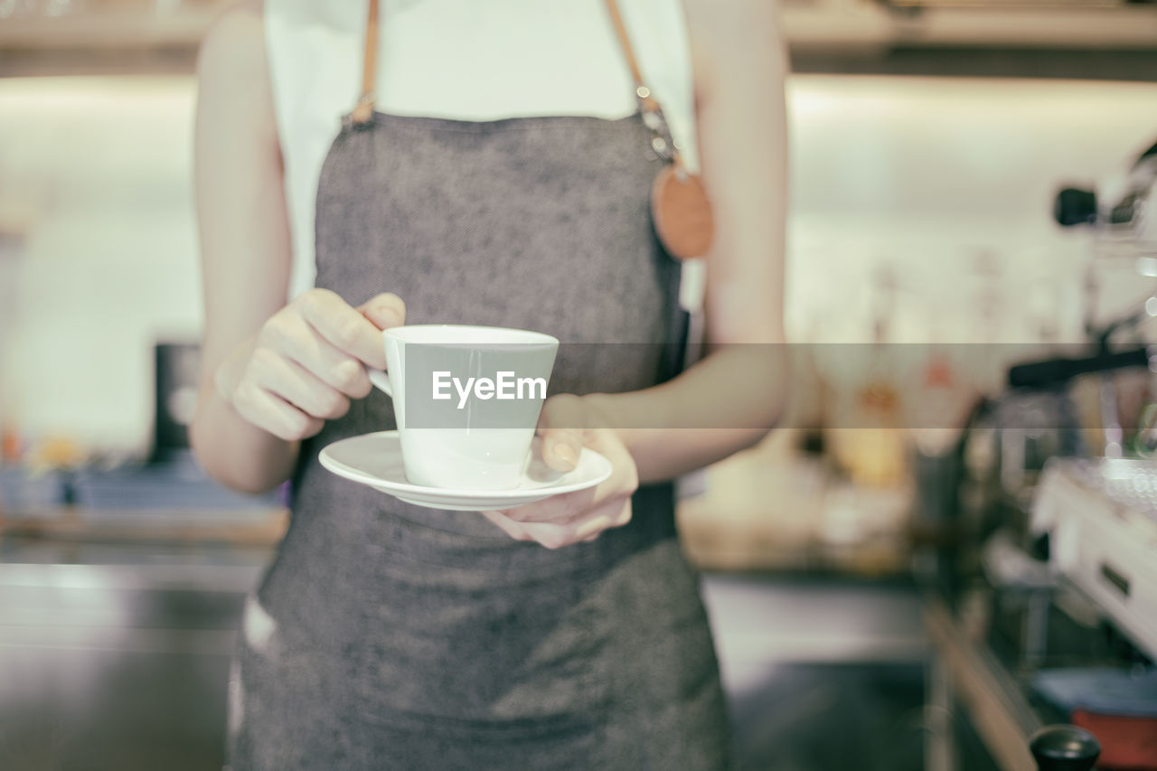 Close-up of woman holding coffee cup