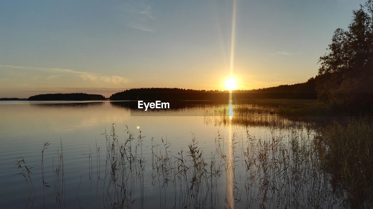 Scenic view of lake against sky during sunset