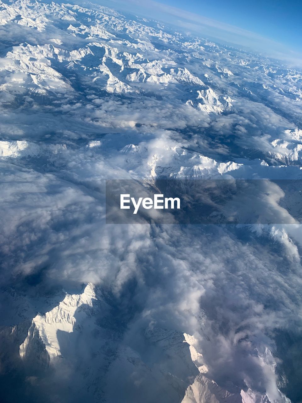 Aerial view of snowcapped mountains against sky