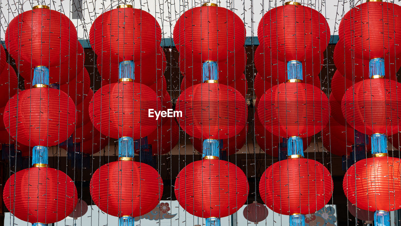 Full frame shot of red lanterns hanging in row