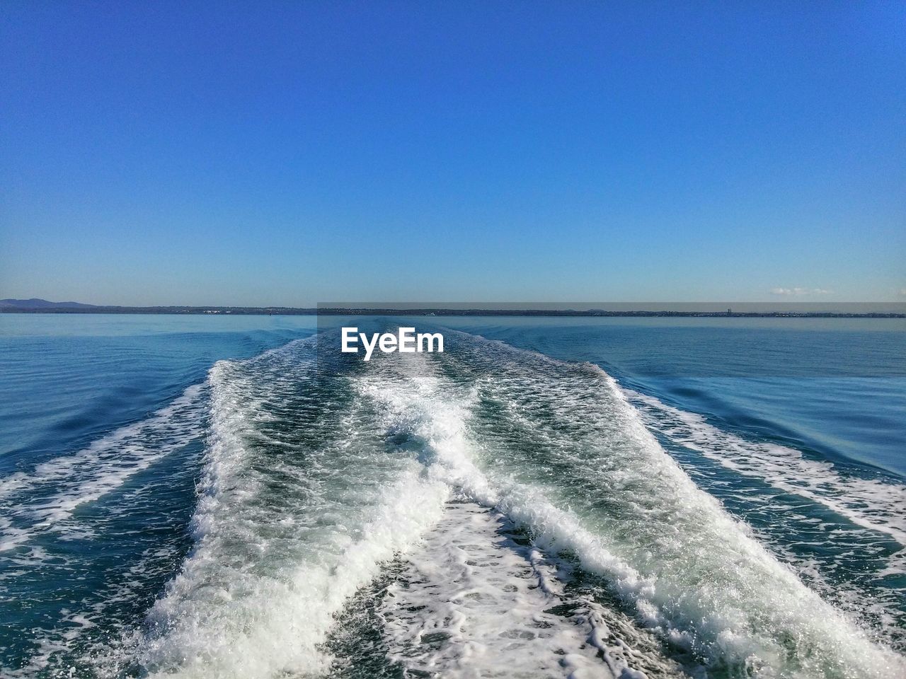 View of calm blue sea against clear sky