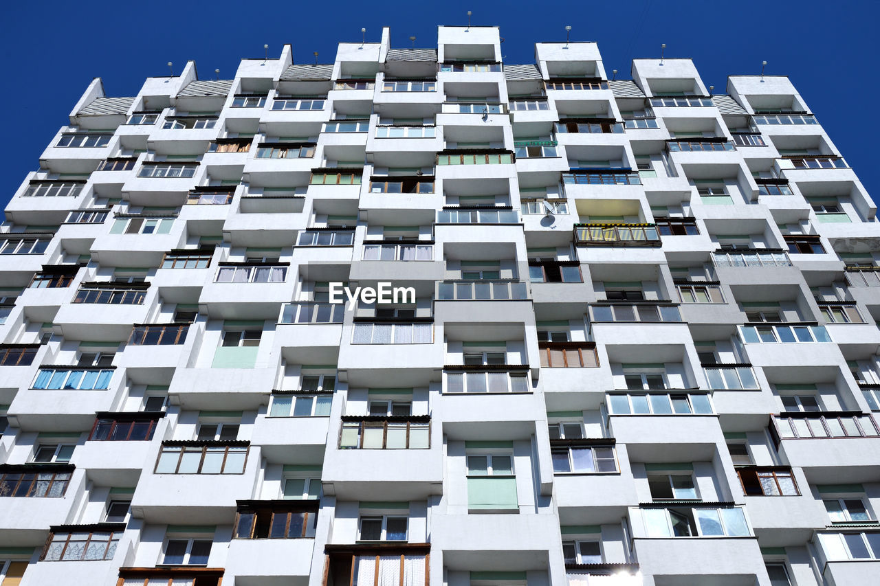 Low angle view of building against clear blue sky