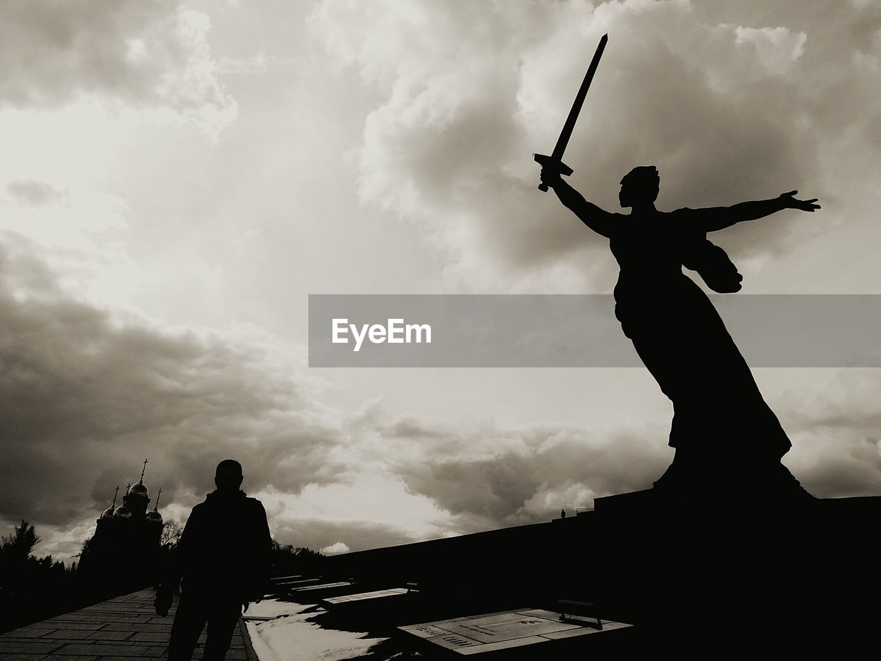 Low angle view of silhouette statue against sky