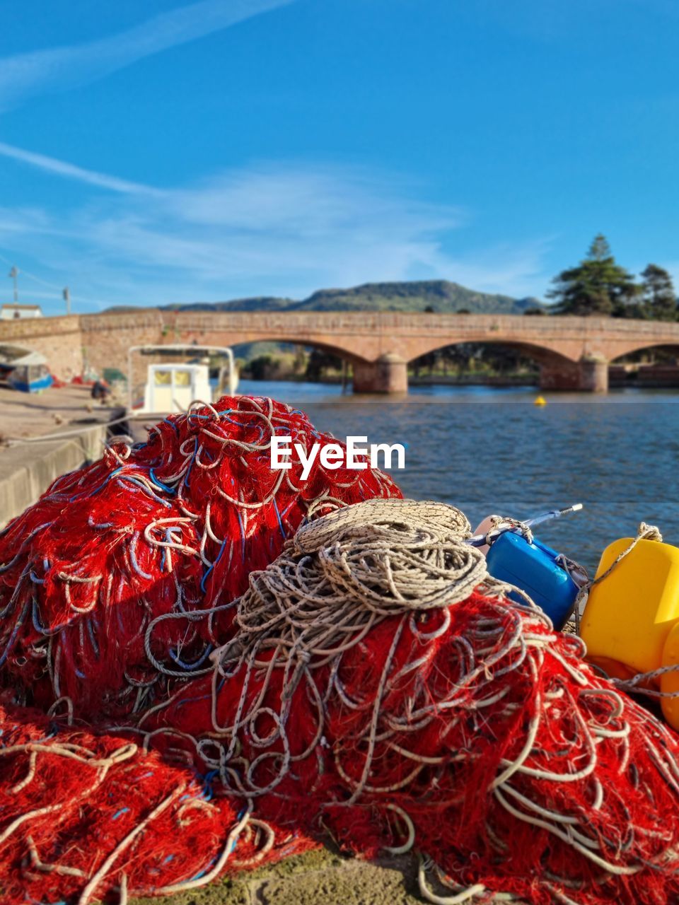 water, fishing industry, fishing, fishing net, buoy, rope, no people, red, nautical vessel, nature, day, commercial fishing net, harbor, sky, transportation, sea, beach, outdoors, fishing rod, blue, rod, land, mode of transportation, pier, large group of objects