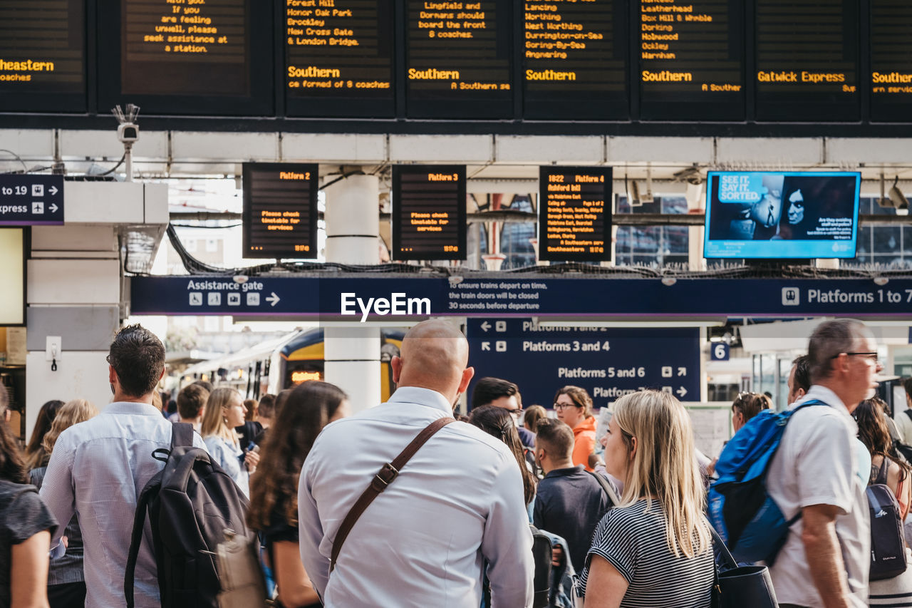 PEOPLE ON RAILROAD STATION PLATFORM