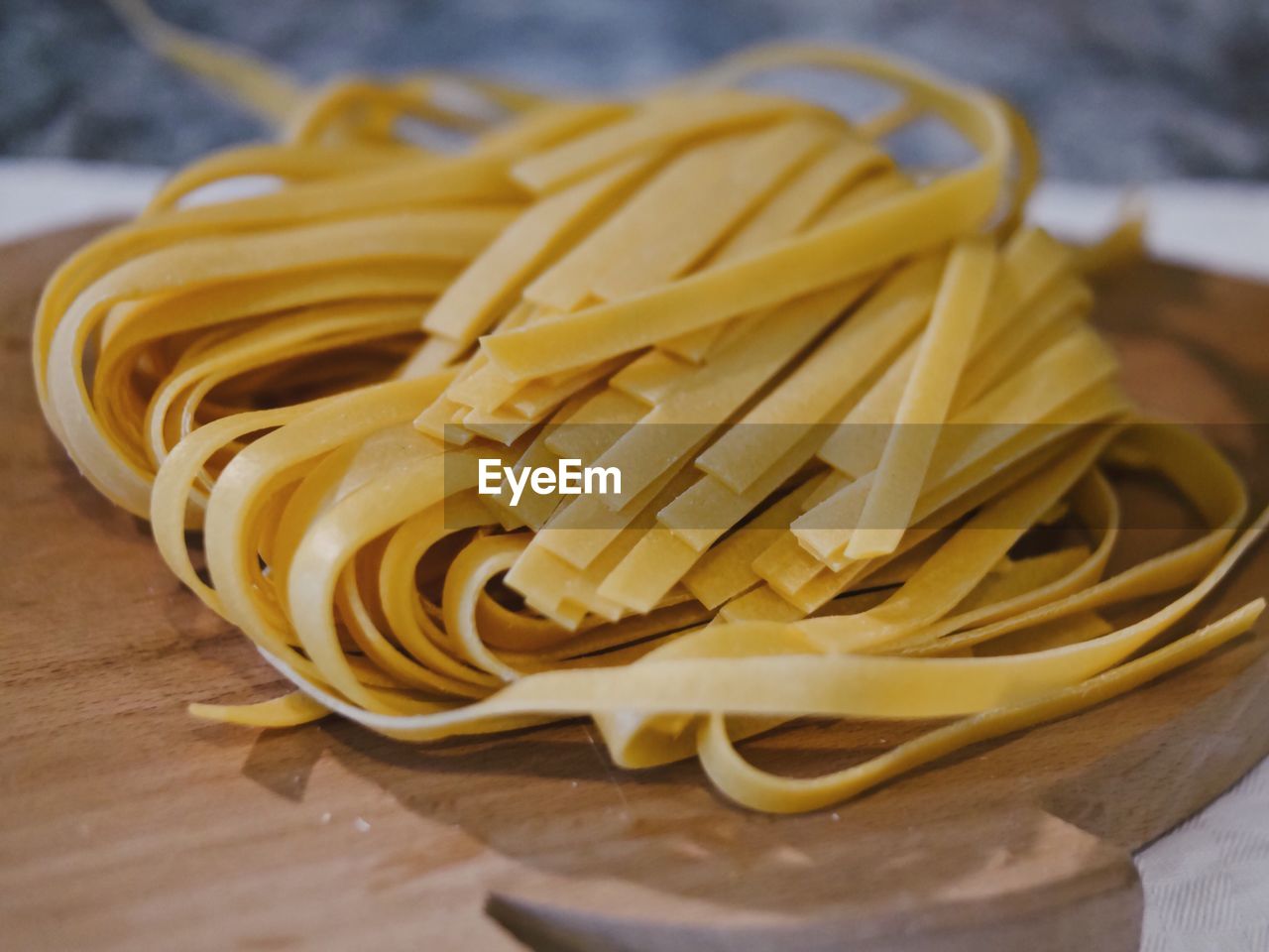 Close-up of raw tagliatelle on cutting board