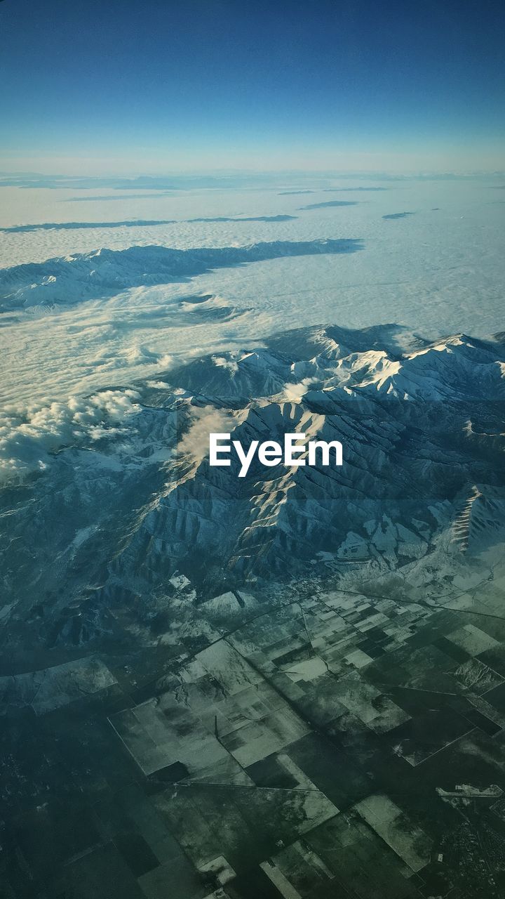 HIGH ANGLE VIEW OF LANDSCAPE AGAINST BLUE SKY