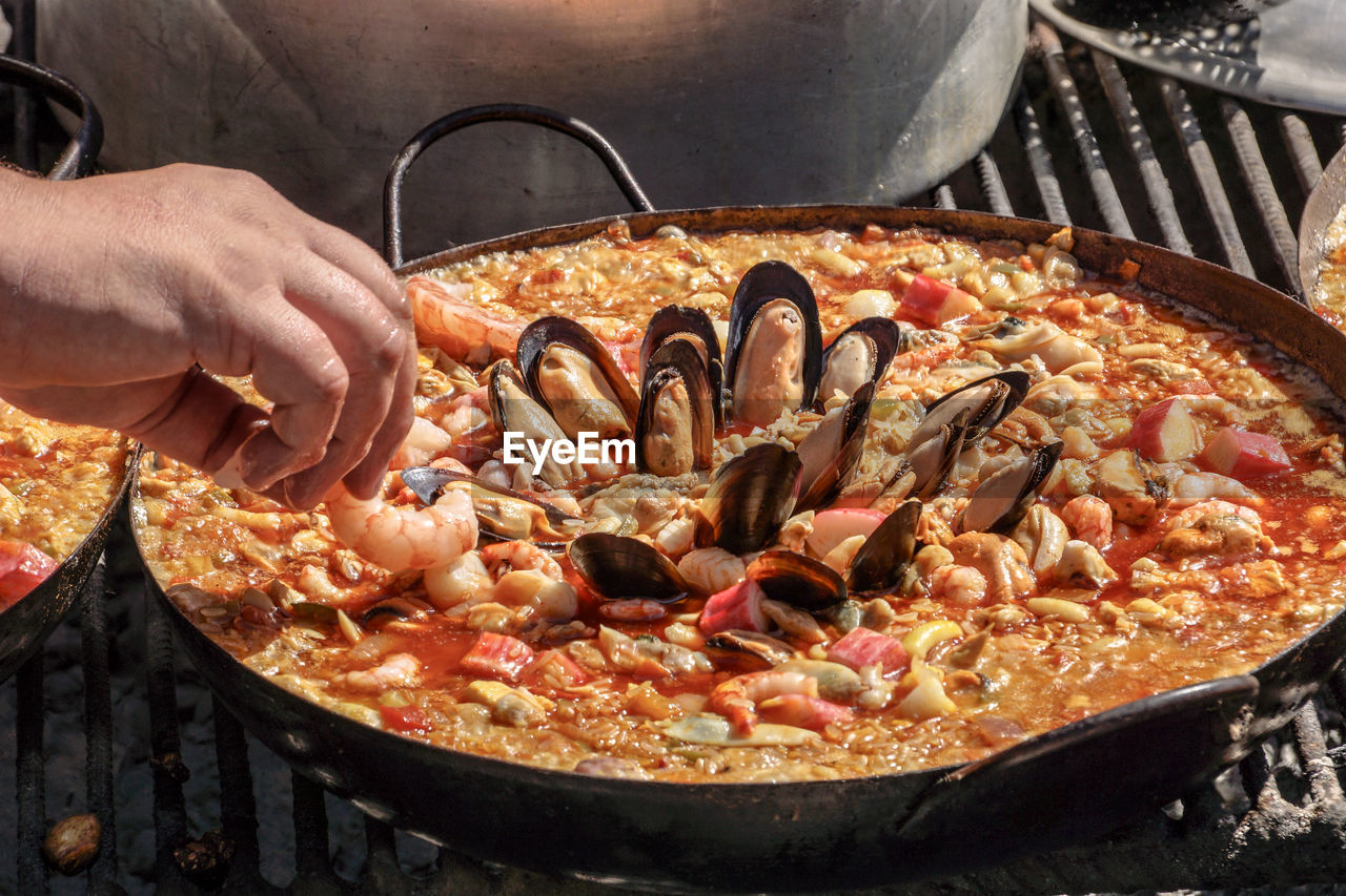 Close-up of person preparing food in container