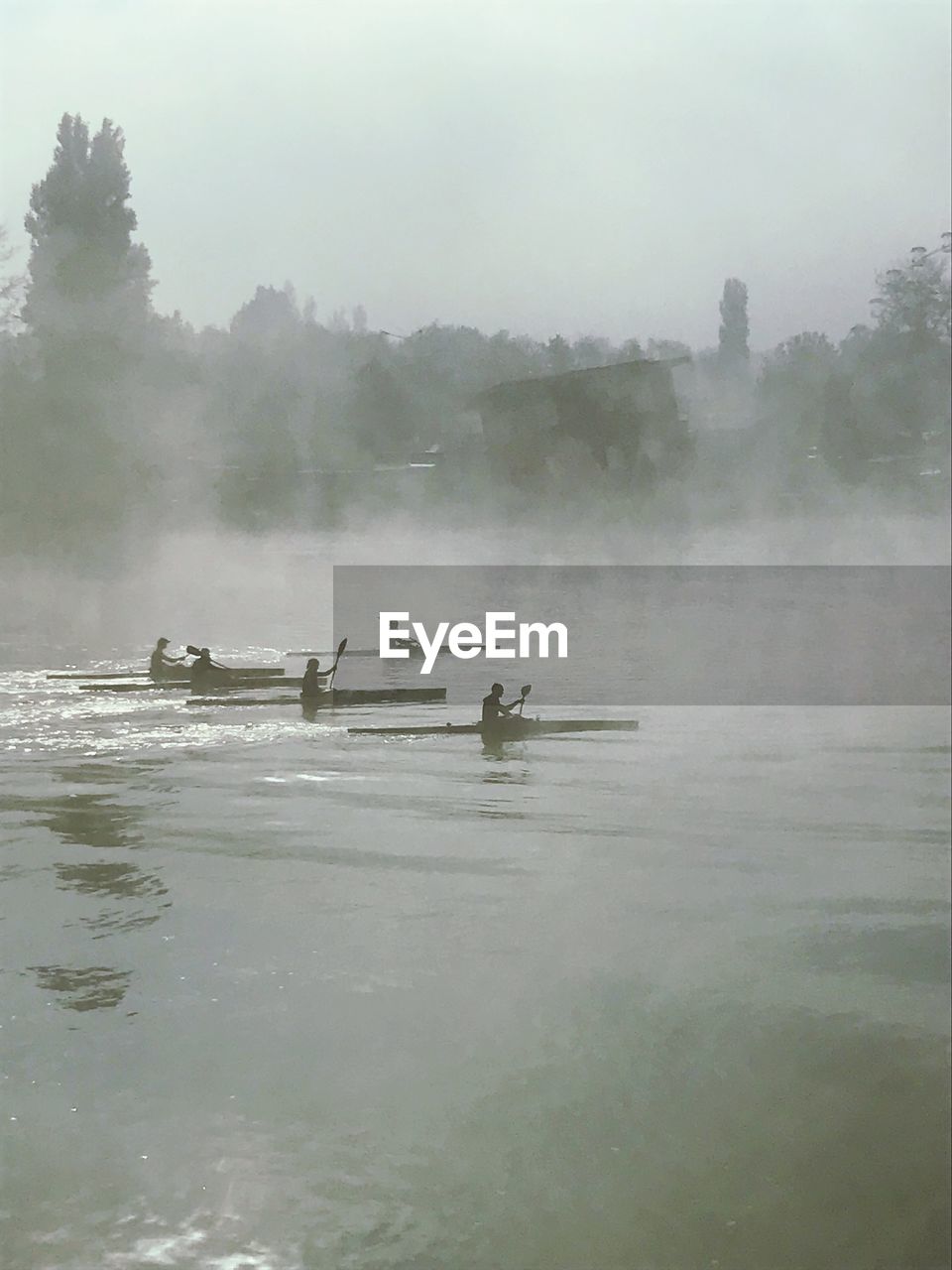 People in kayaks on river