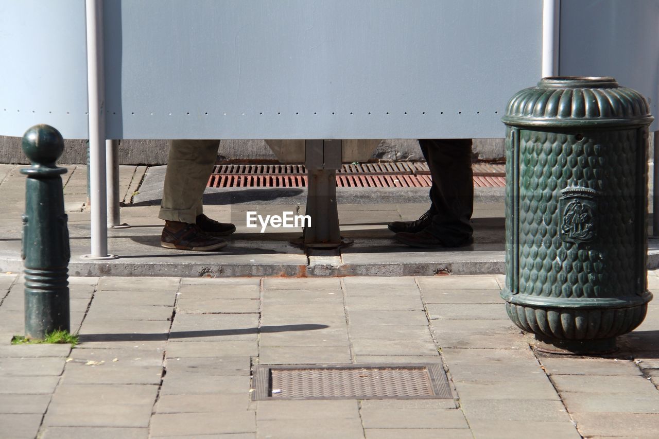 Low section of men urinating at public restroom