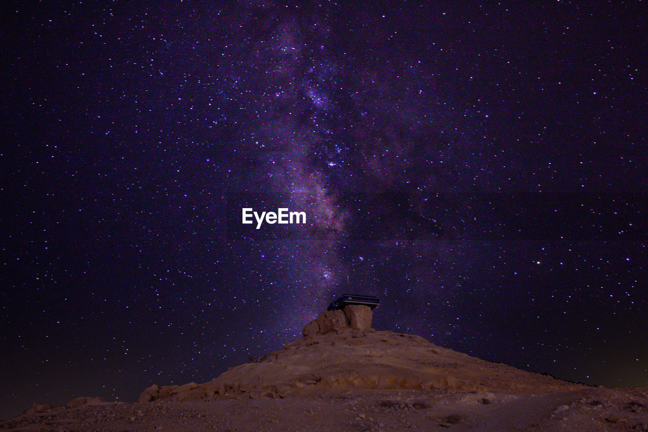 Milky way long exposure with an observatory and a desert foreground