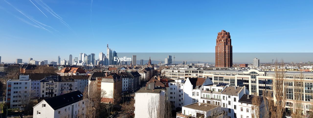 Modern buildings in city against clear sky