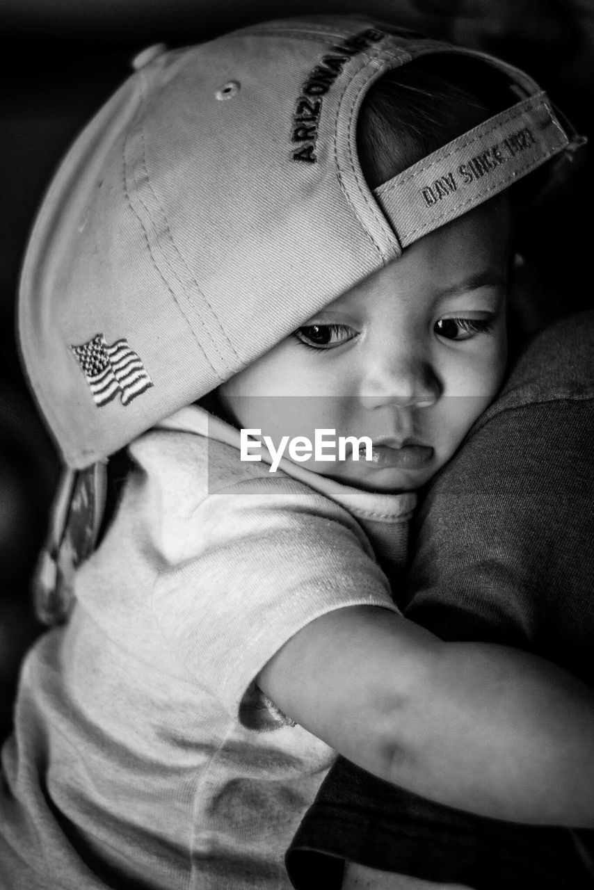 CLOSE-UP PORTRAIT OF CUTE BOY WEARING HAT