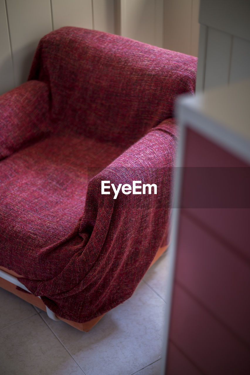 High angle view of armchair on floor at home