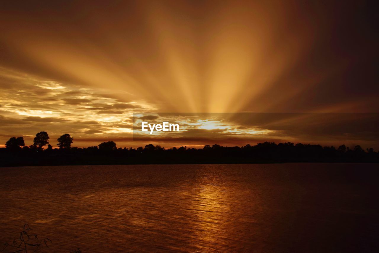 Scenic view of lake against romantic sky at sunset