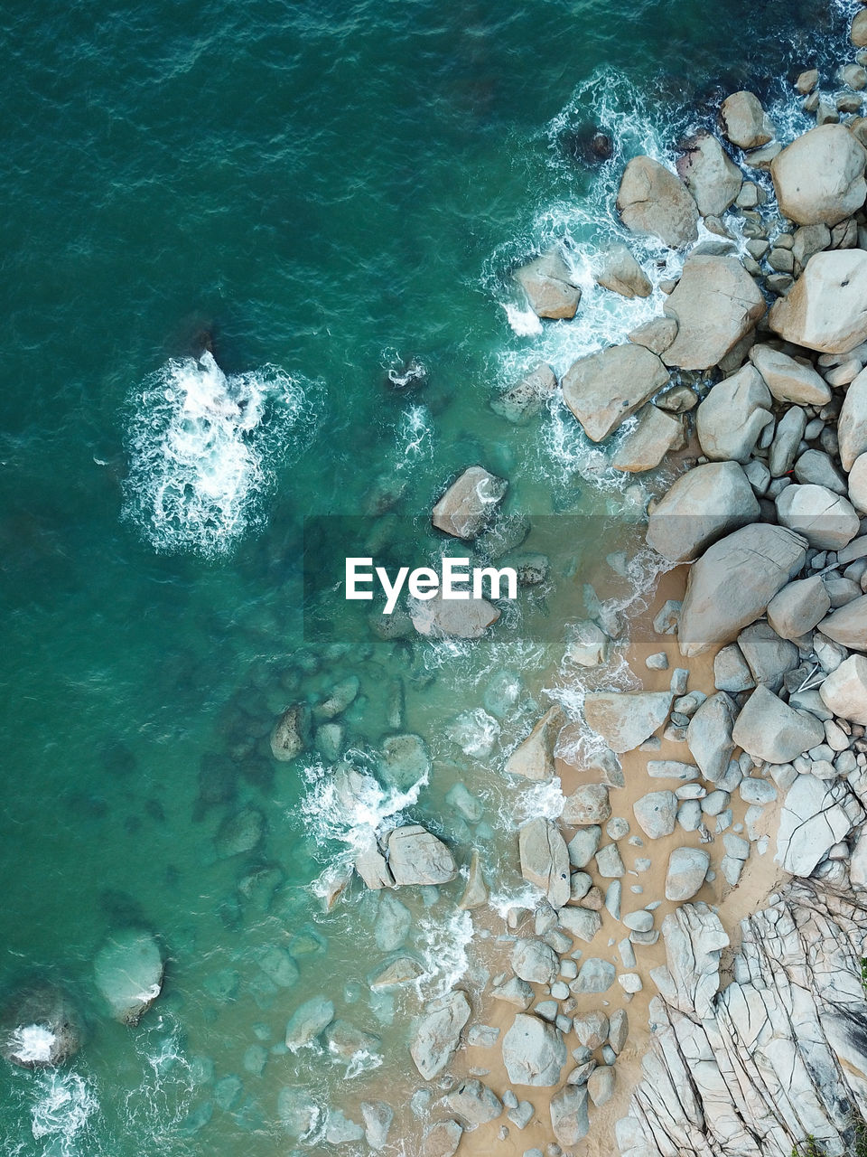 High angle view of rocks by sea