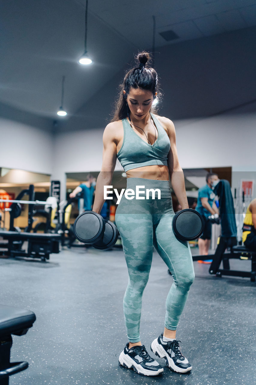 Side view of woman exercising in gym