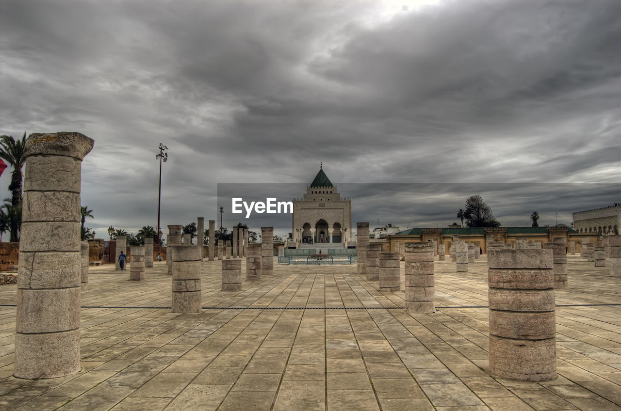 architecture, cloud, sky, built structure, travel destinations, history, religion, the past, building exterior, nature, belief, landmark, place of worship, travel, spirituality, city, ancient history, building, storm, tourism, overcast, storm cloud, outdoors, temple, dramatic sky, street, cloudscape