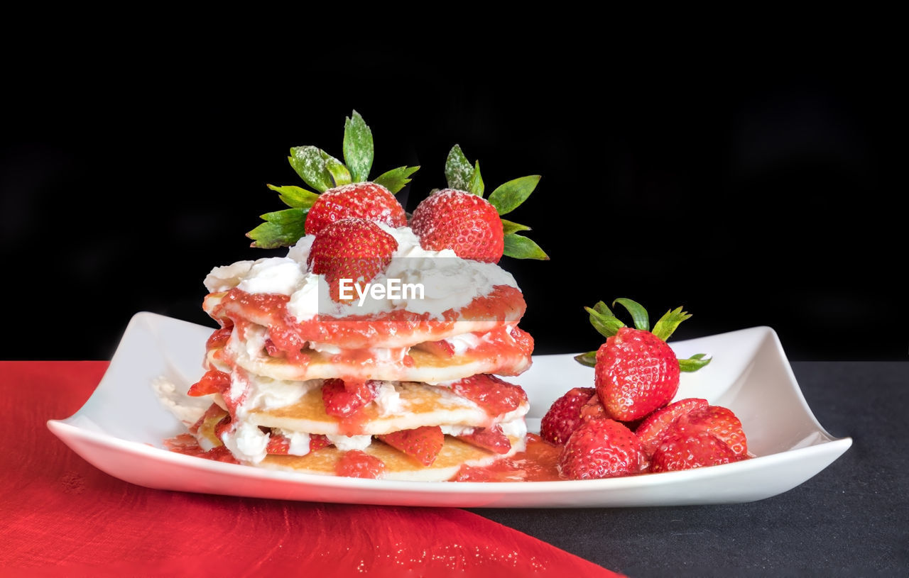 Close-up of strawberriy pancakes in a plate on table