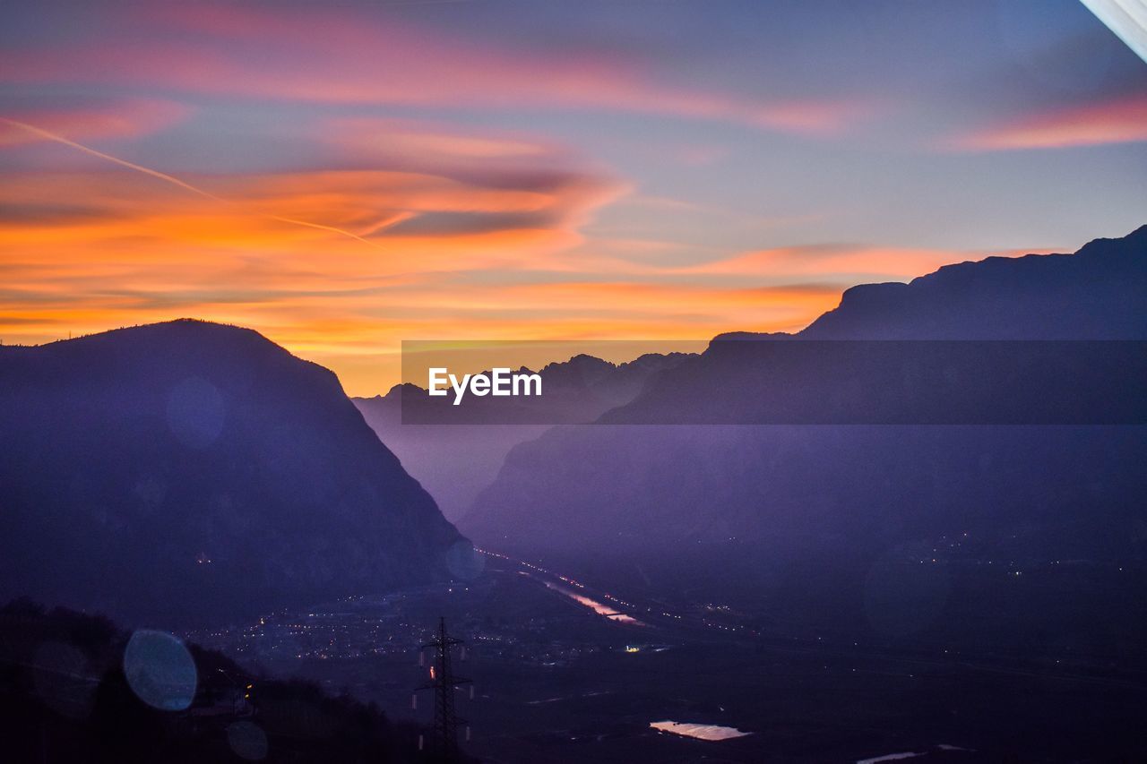 Scenic view of silhouette mountains against sky during sunset