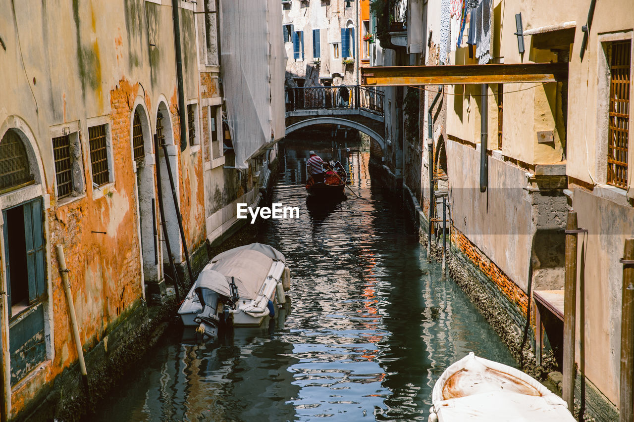 HIGH ANGLE VIEW OF CANAL BY BUILDINGS