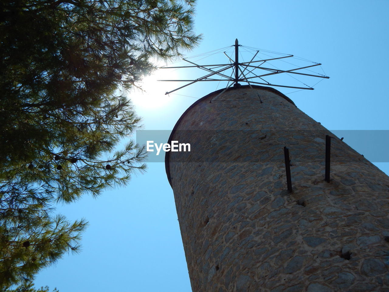 Low angle view of traditional windmill against sky