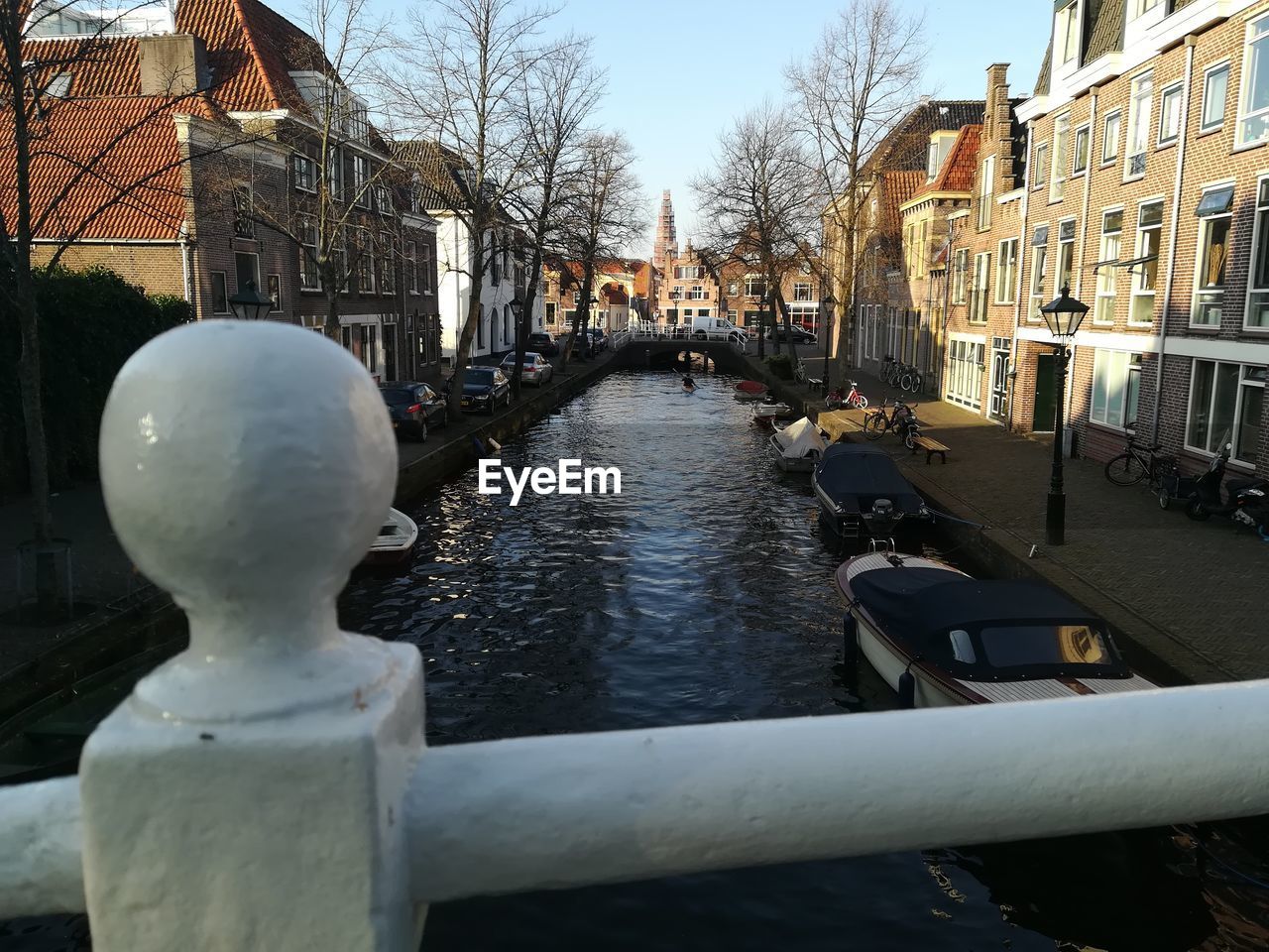 Bridge over canal amidst buildings in city