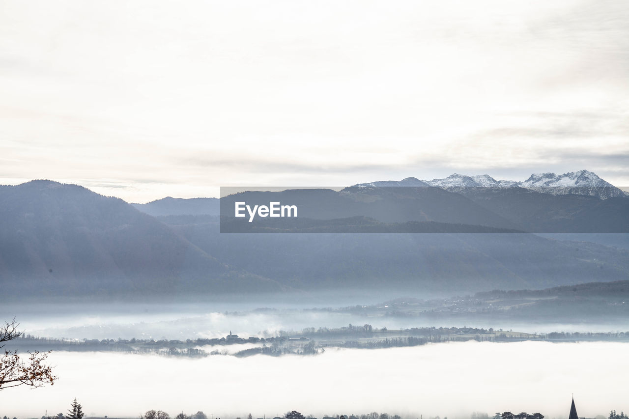 mountain, environment, landscape, scenics - nature, fog, beauty in nature, morning, sky, mountain range, nature, cold temperature, cloud, snow, winter, land, tree, tranquility, tranquil scene, plant, no people, water, horizon, mist, forest, travel, travel destinations, lake, outdoors, non-urban scene, dawn, day, rural scene, tourism, copy space, idyllic, coniferous tree, pinaceae, mountain peak, sunlight