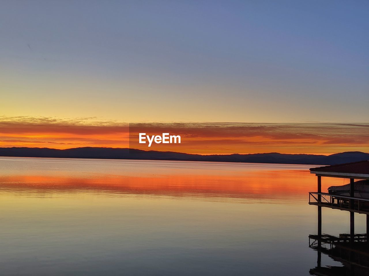 VIEW OF LAKE AGAINST SKY DURING SUNSET