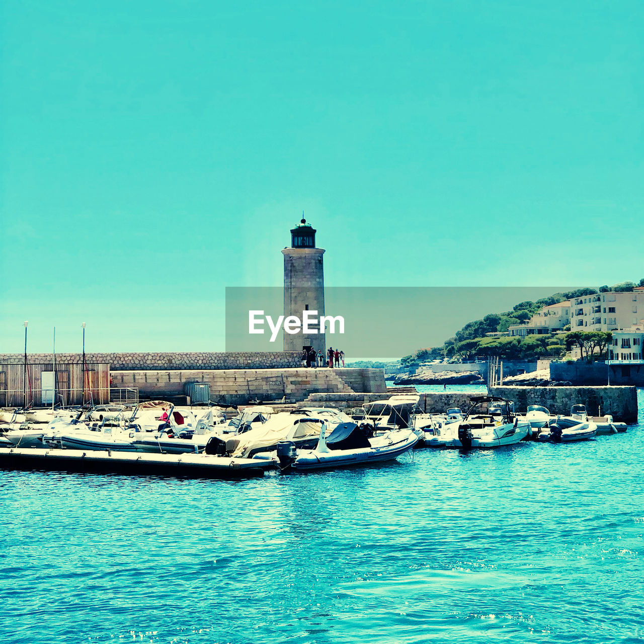 VIEW OF LIGHTHOUSE AND BUILDINGS AGAINST CLEAR SKY