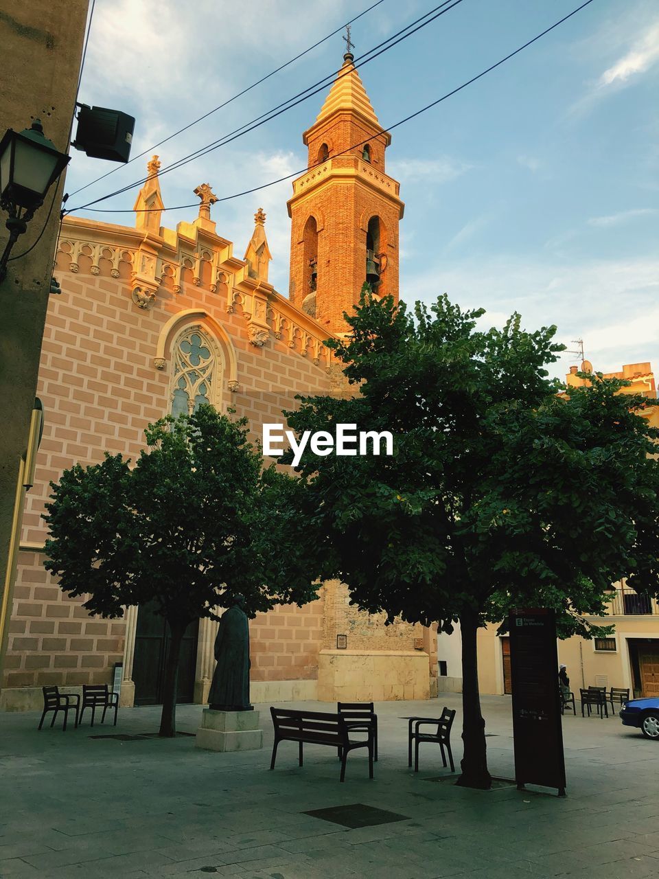 VIEW OF TREES AND BUILDING AGAINST SKY