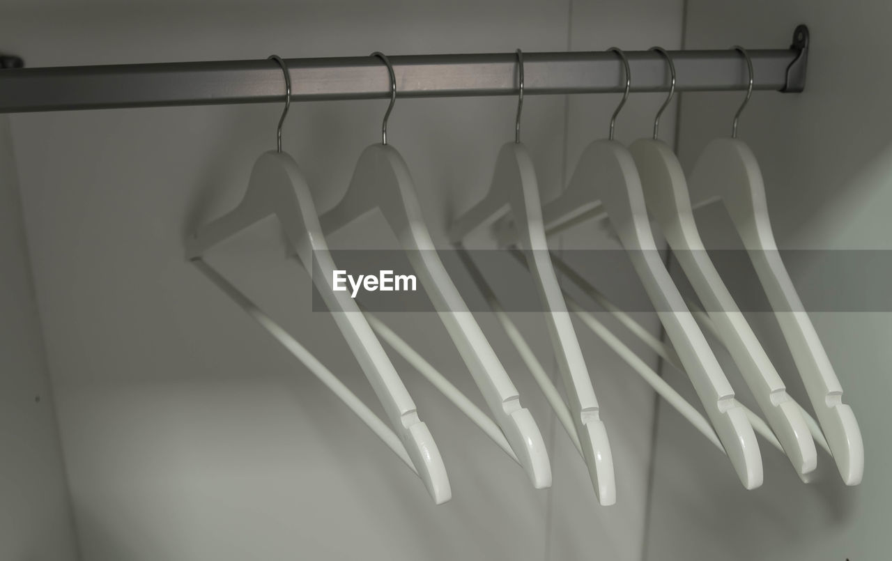 Wooden hangers. close up of white hangers. clothes on a rail