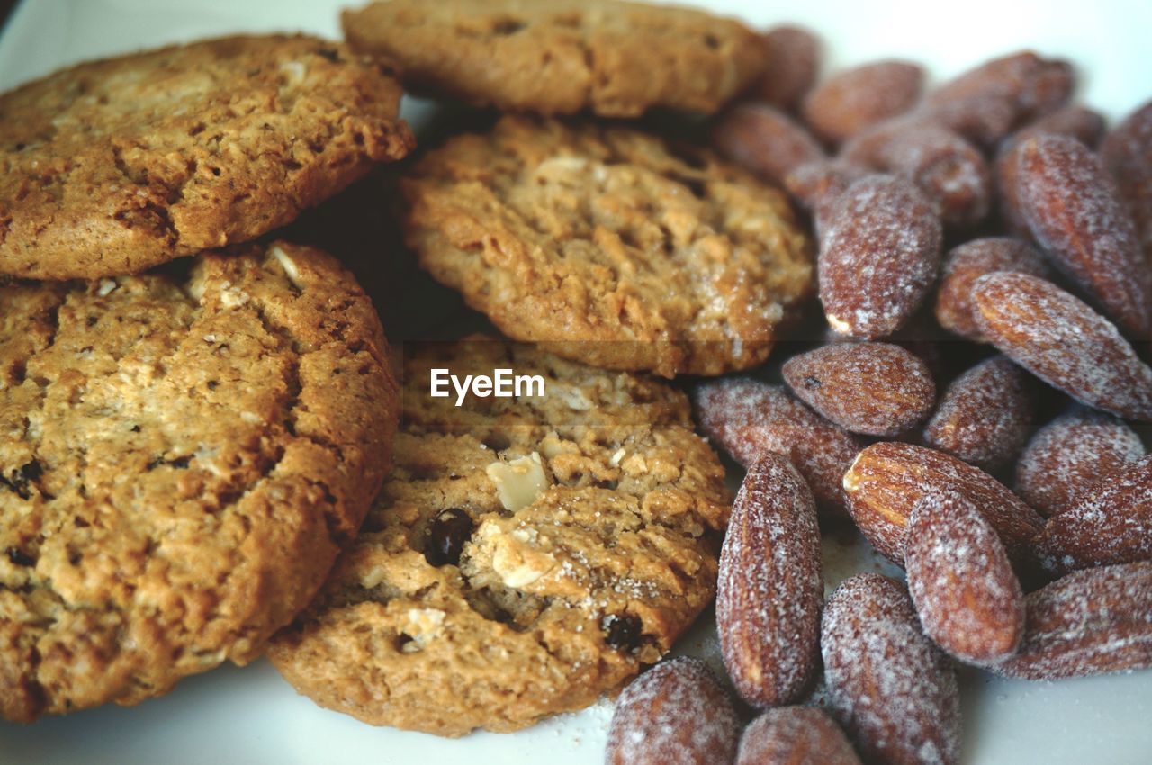 Close-up of cookies and almonds in plate