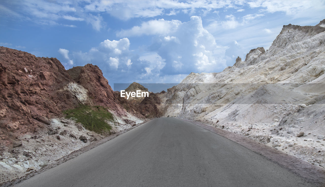 Road amidst mountains against sky