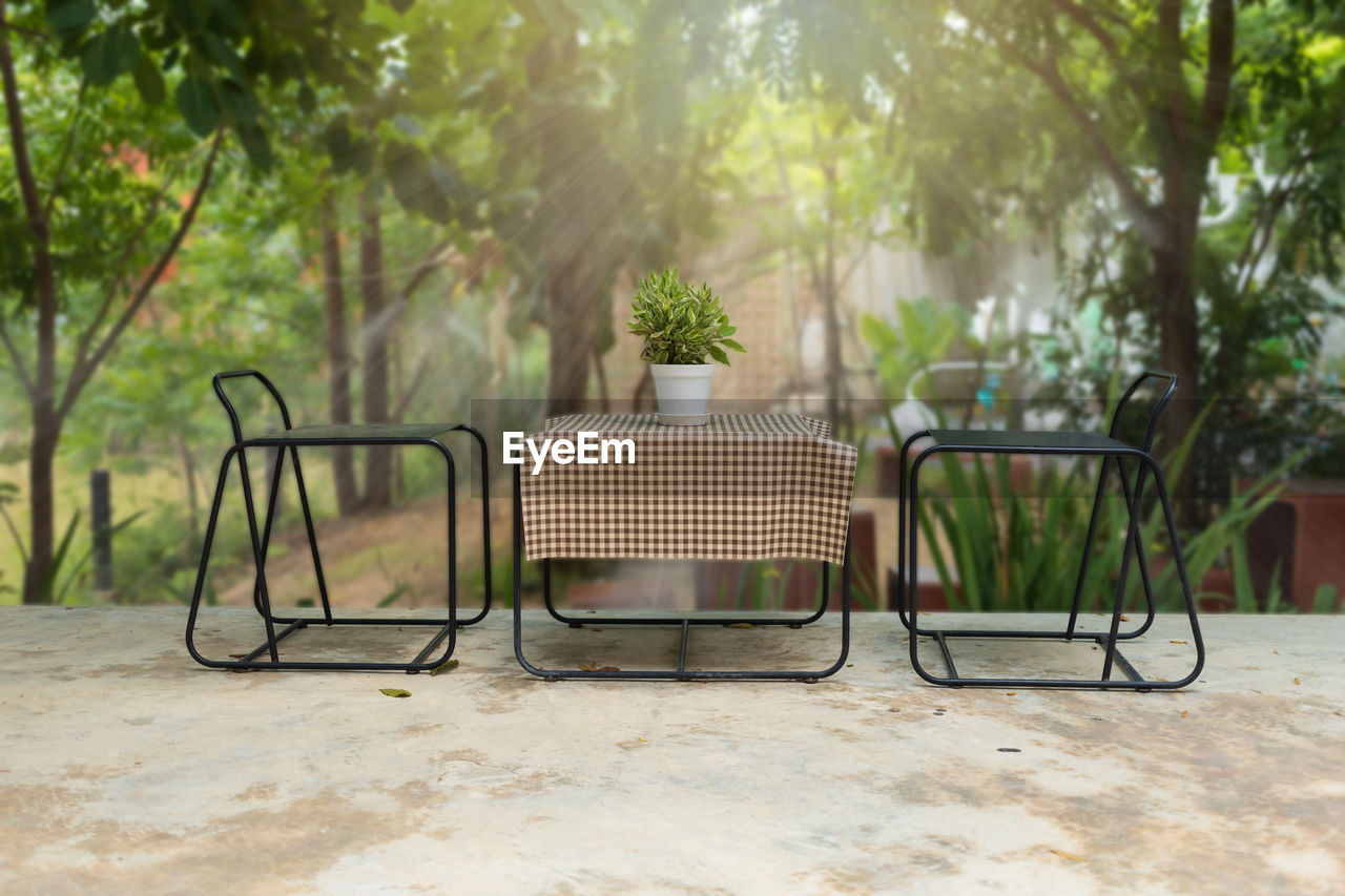 Elegant metal garden furniture on terrace with tables and chairs with clipping patch.