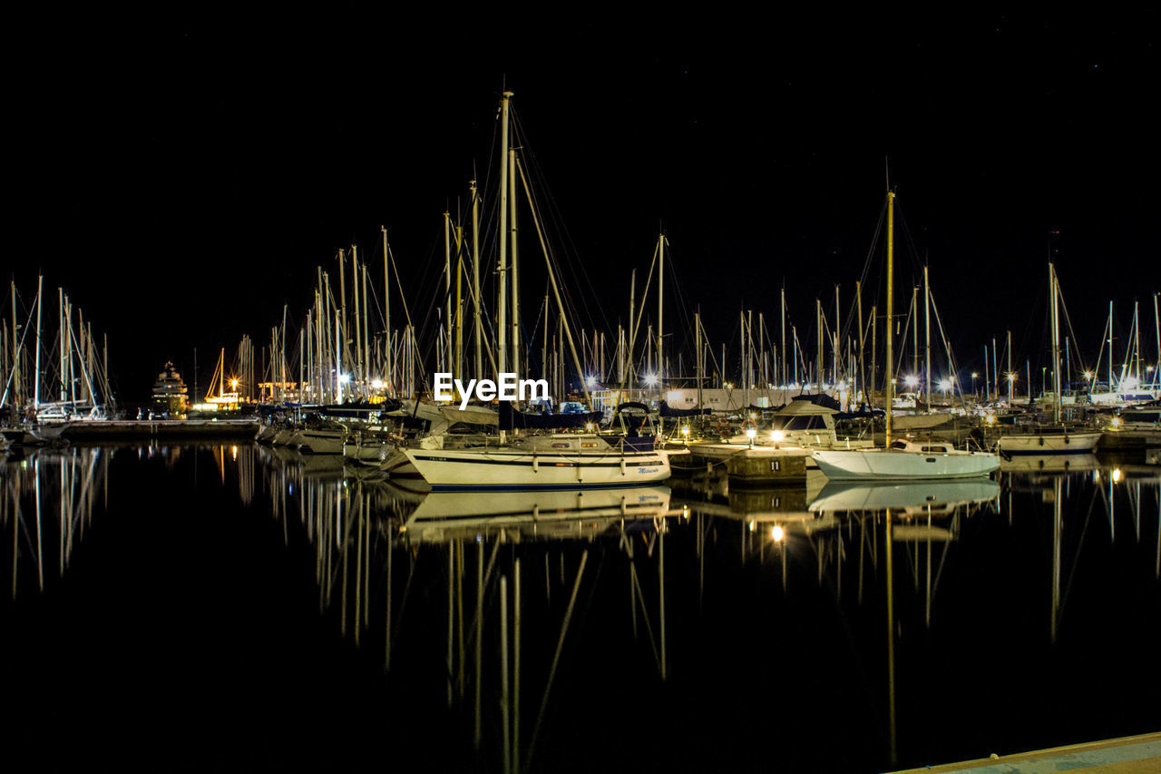 SAILBOATS MOORED IN SEA