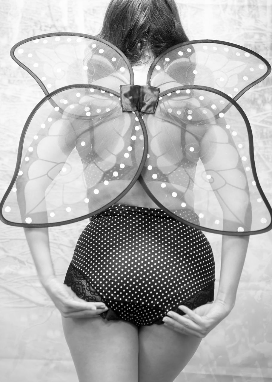 Rear view sexy seductive women model wearing polka dot showing off angel costume lingerie