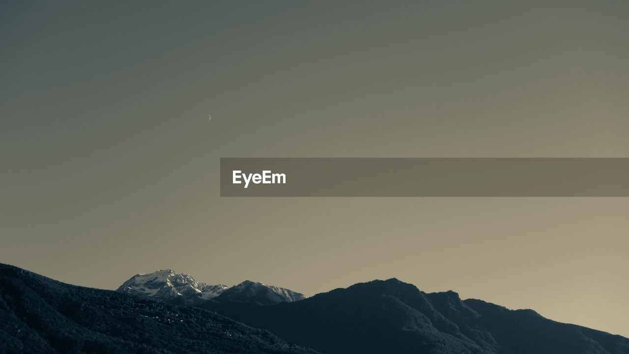 SNOWCAPPED MOUNTAINS AGAINST CLEAR SKY