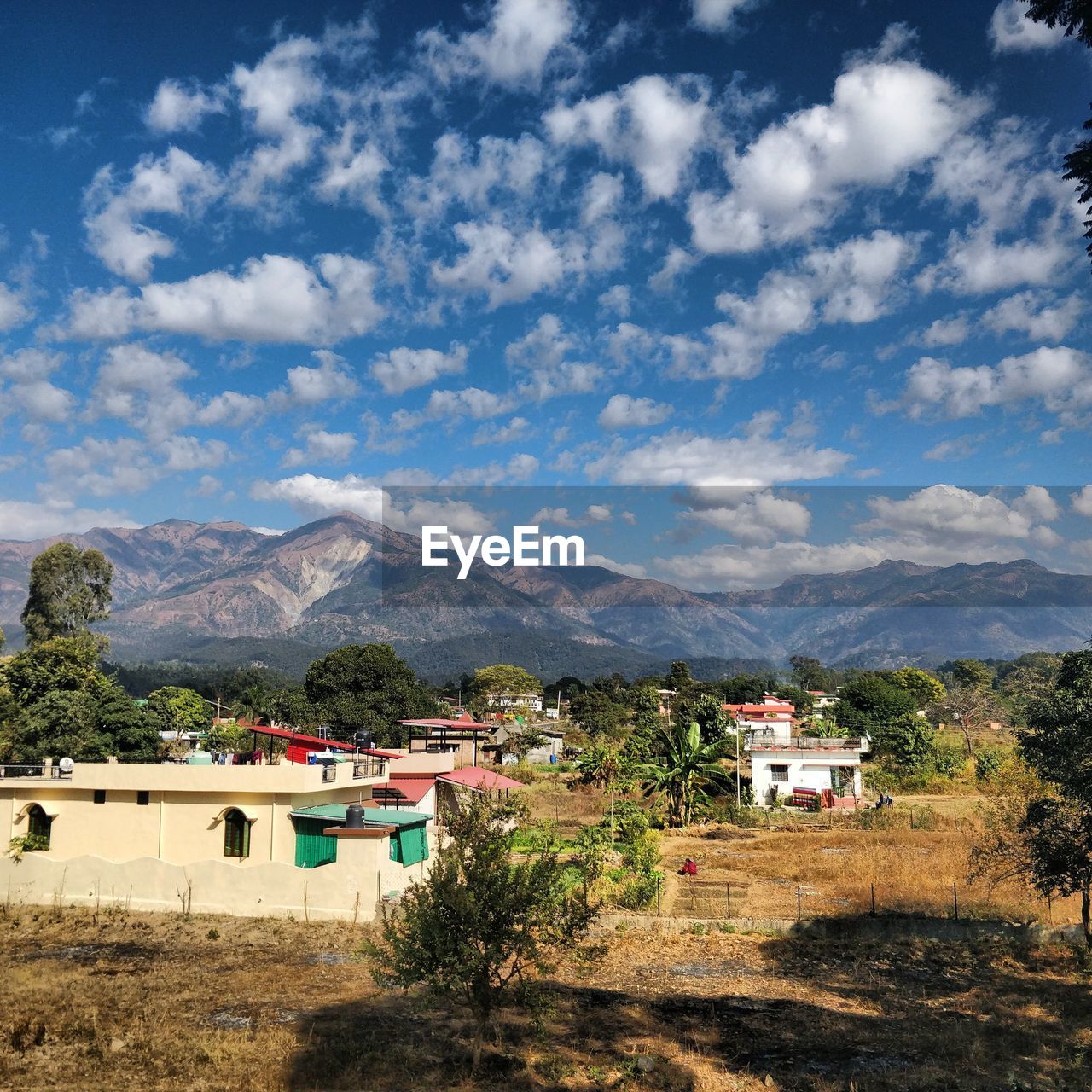 Houses by mountains against sky