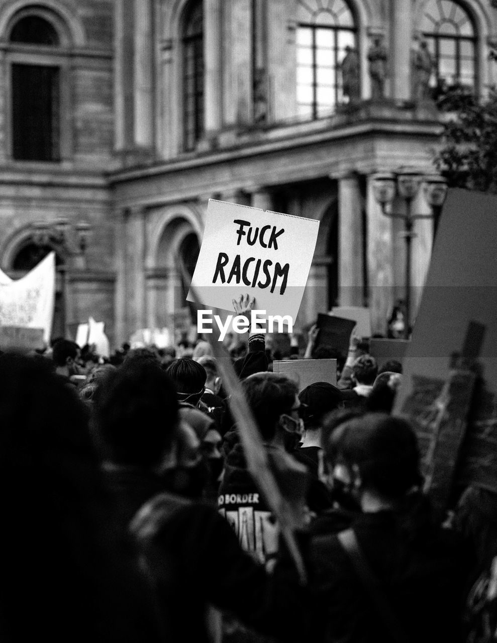 Group of people protesting in front of building