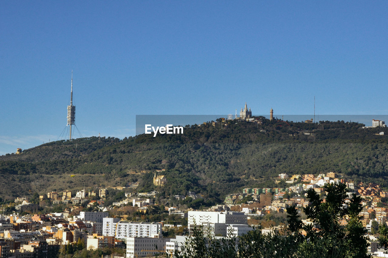 View of town against clear blue sky