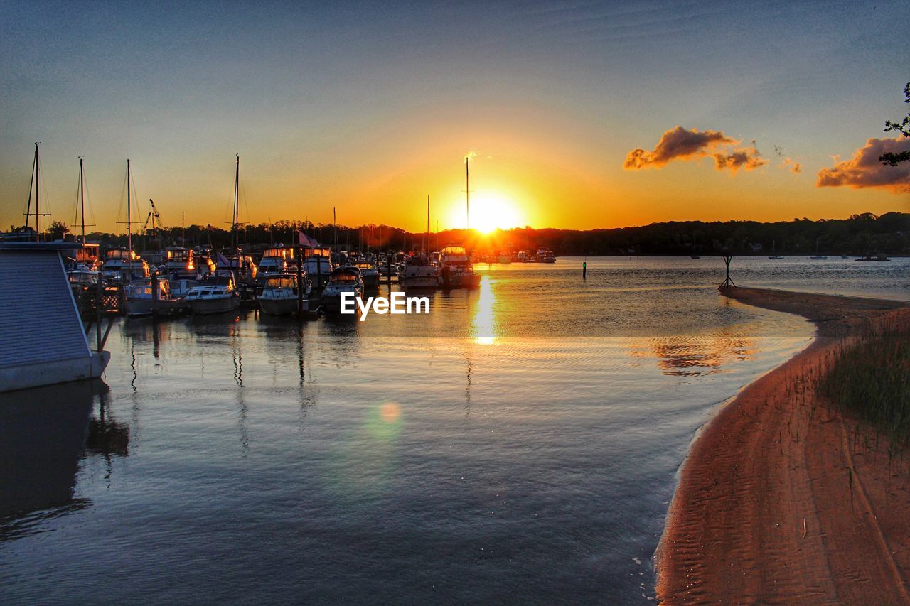 BOATS IN HARBOR AT SUNSET