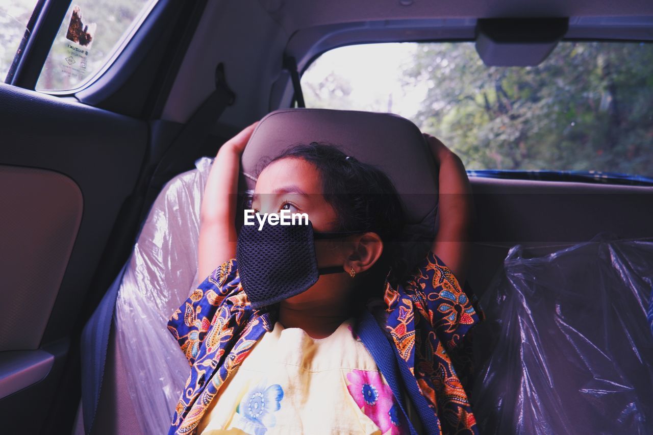 Portrait of young girl in car